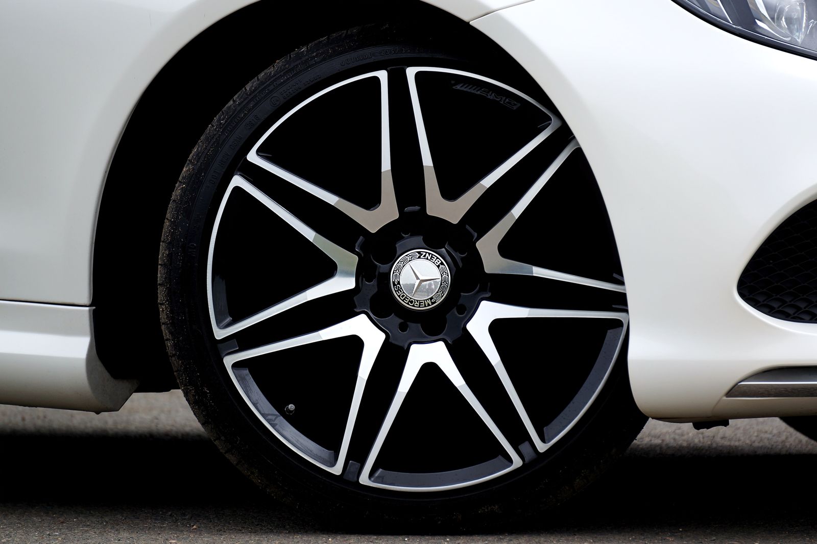 Close-up of a polished alloy wheel on a white car